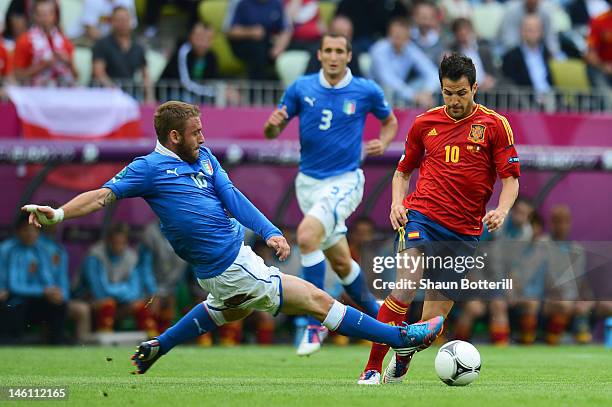 Antonio Cassano of Italy tackles Cesc Fabregas of Spain during the UEFA EURO 2012 group C match between Spain and Italy at The Municipal Stadium on...