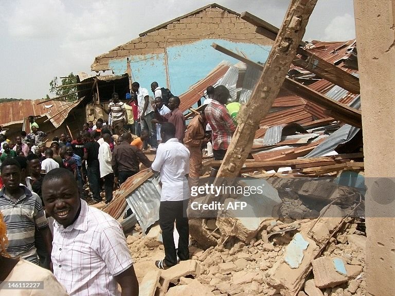 People gather outside the ruins of a chu