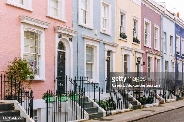 street with multicolored townhouses in notting hill, london, uk - kensington stock pictures, royalty-free photos & images