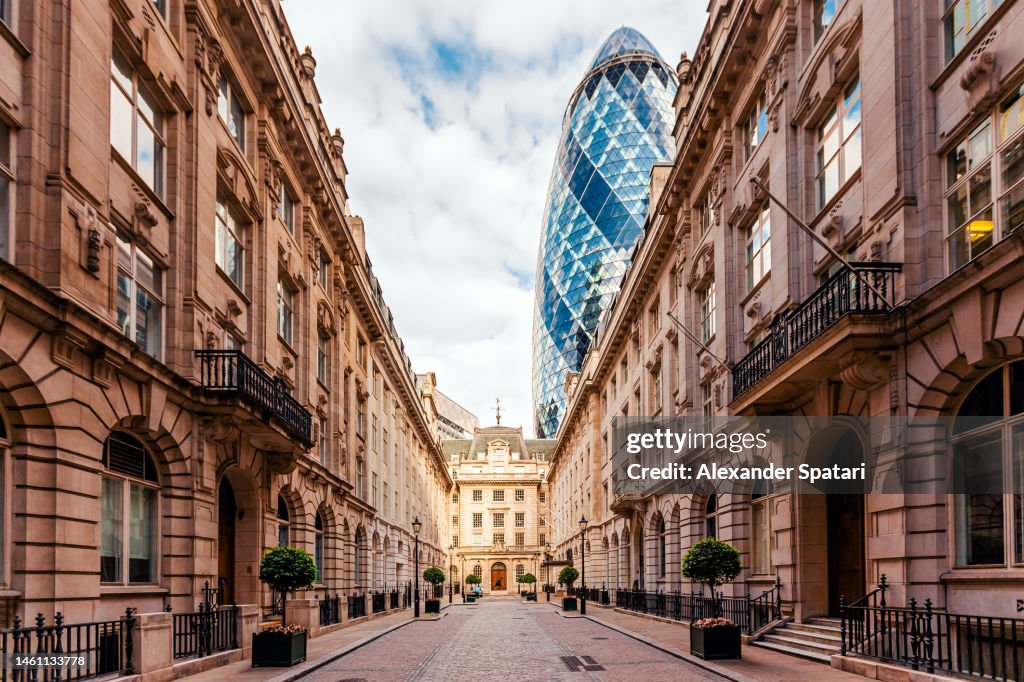 30 St Mary Axe (The Gerkin) among old historic houses in London, UK