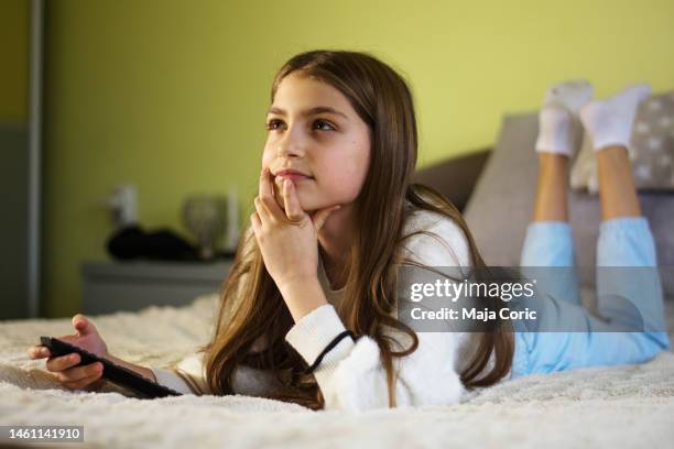 girl enjoying watching her favorite movie at home - alter tv stock pictures, royalty-free photos & images