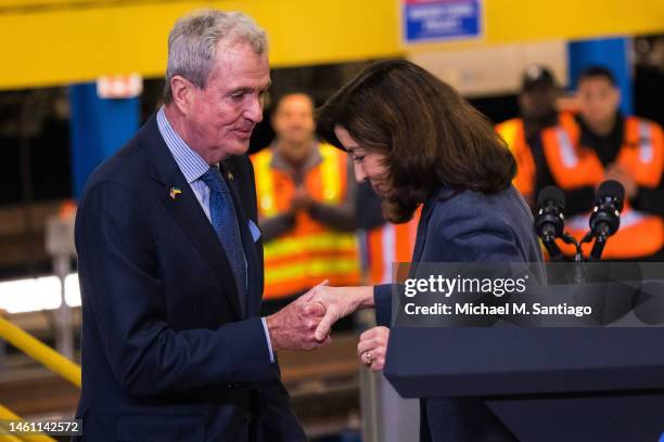 New Jersey Gov. Phil Murphy helps New York Gov. Kathy Hochul off the stage after giving a speech on the Hudson River tunnel project at the West Side...