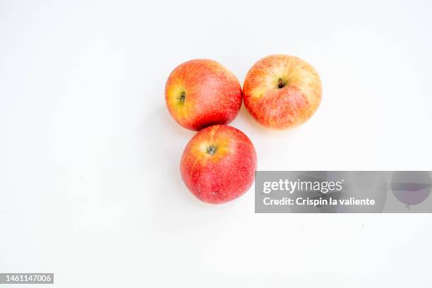 three red apples isolated on a white background - apple white background stock-fotos und bilder