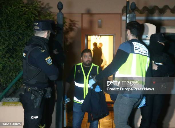 Policeman carries evidence from the house where the bodies of a man and a woman shot dead were found on January 31, 2023 in La Linea . This...