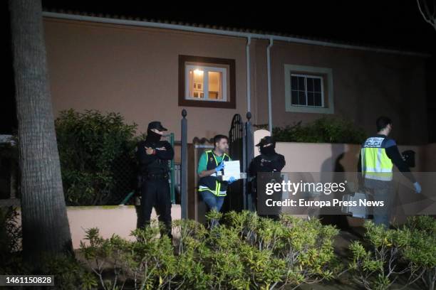 Policeman carries evidence from the house where the bodies of a man and a woman shot dead were found on January 31, 2023 in La Linea . This...