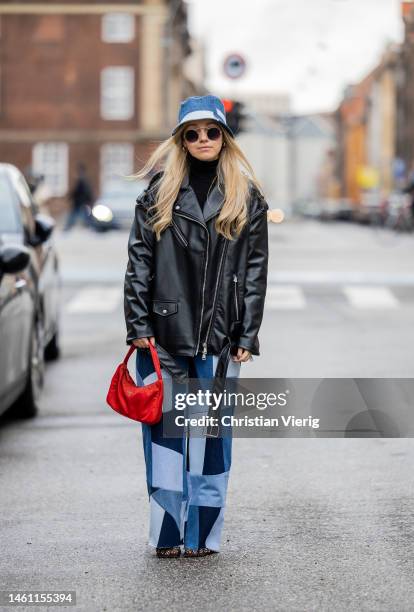 Joicy Muniz wears checkered patched jeans Nearon Studio, bucket denim hat Nearon Studio, red bag Prada, shoes Bottega Veneta, black leather jacket,...