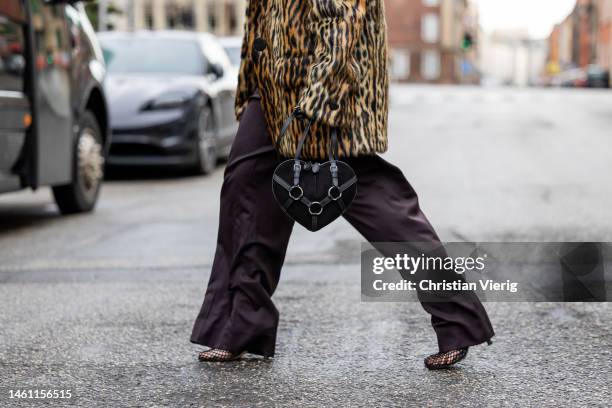 Joicy Muniz wears leopard print coat Stand Studio, black bodysuit Mugler, wide leg pants Attire, bag Maison Alaia, earrings Trine Tuxen, shoes...