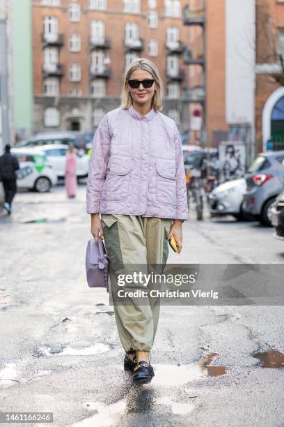 Hollie Mercedes Peters wears rose quilted jacket, two tone khaki green cargo pants, loafers, bag and outside Rabens Saloner during the Copenhagen...