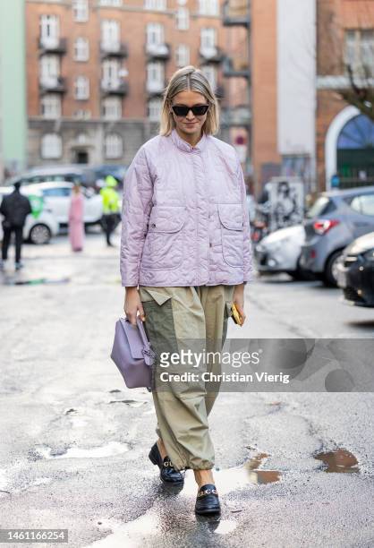 Hollie Mercedes Peters wears rose quilted jacket, two tone khaki green cargo pants, loafers, bag and outside Rabens Saloner during the Copenhagen...