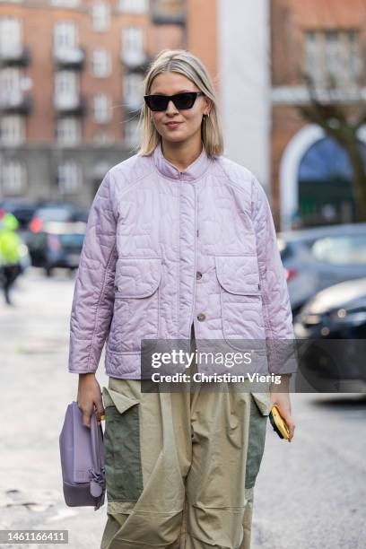 Hollie Mercedes Peters wears rose quilted jacket, two tone khaki green cargo pants, loafers, bag and outside Rabens Saloner during the Copenhagen...