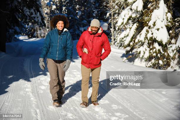 young couple hiking in winter - african american hiking stock pictures, royalty-free photos & images