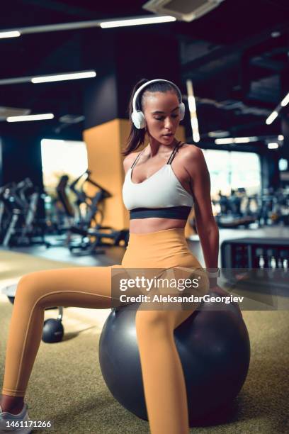 seated female getting ready for fitness ball core workout - weight stock pictures, royalty-free photos & images