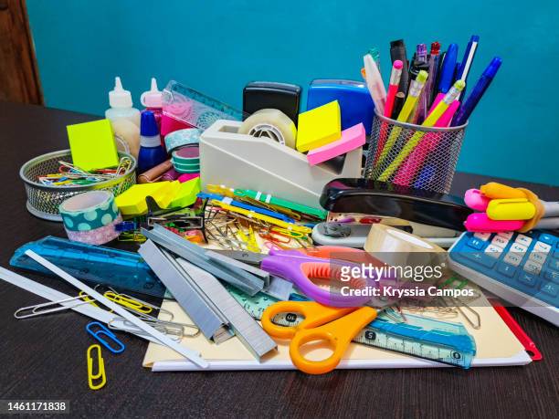 group of school or office supplies on a desk - staples office stockfoto's en -beelden