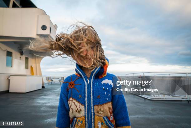 a young girl on ferry boat deck with wind blowing her hair - tousled hair stock pictures, royalty-free photos & images