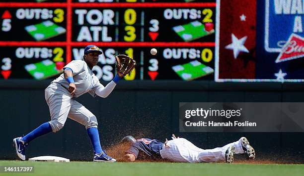 Starlin Castro of the Chicago Cubs catches the ball as Ben Revere of the Minnesota Twins steals second base during the first inning on June 10, 2012...