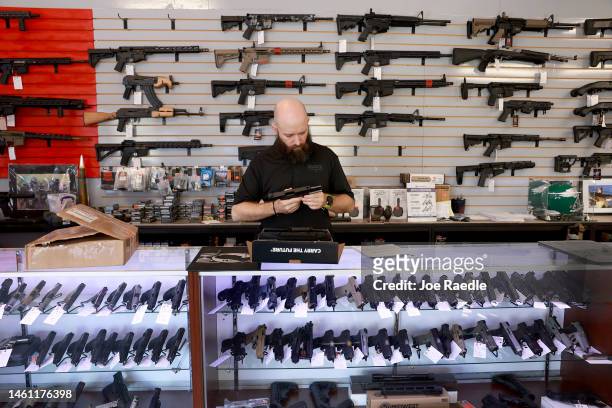 Ian Bravender inventories a handgun at the WEX Gunworks store on January 31, 2023 in Delray Beach, Florida. The state of Florida may become the 26th...