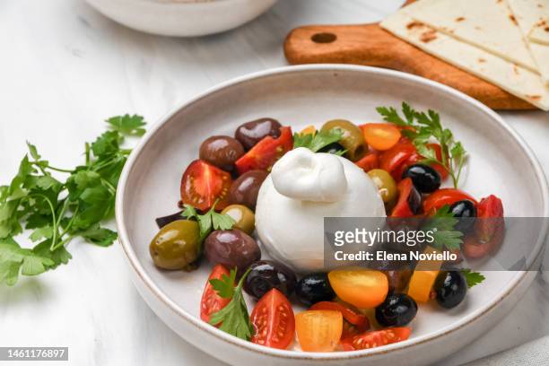 caprese salad , italian burrata cheese salad with tomatoes, olives and olive oil. healthy diet proteins vegetables - dieta mediterranea foto e immagini stock
