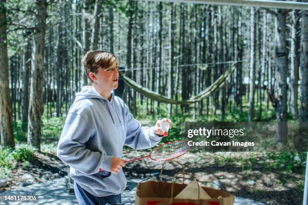 teen boy with badminton set outside in forest - colter bay stock pictures, royalty-free photos & images