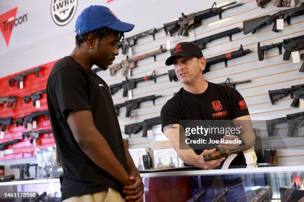 Brandon Wexler helps Kimani O'Reilly shop for a handgun at his WEX Gunworks store on January 31, 2023 in Delray Beach, Florida. The state of Florida...