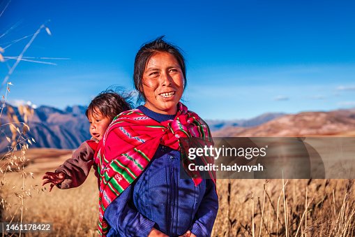 Peruvian woman carrying her baby on the back near Cuzco