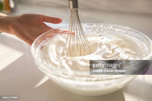 female hands using electric mixer to make whipped cream - maräng bildbanksfoton och bilder