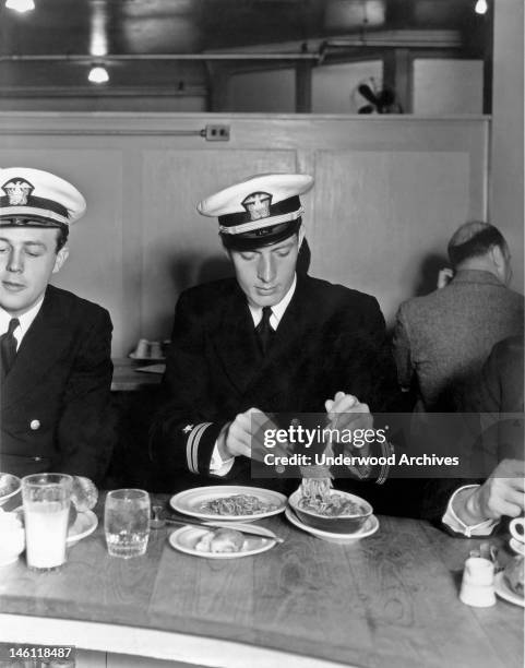 Star tennis player Frank Shields digs into a spaghetti dish at the studio commissary, Hollywood, California, mid 1930s.