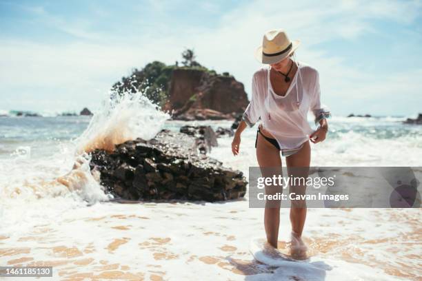 a beautiful girl washes away with a wave - colombo stock pictures, royalty-free photos & images