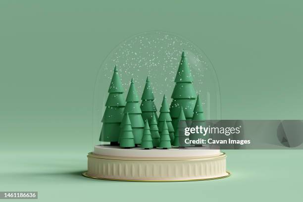 christmas trees inside snow dome. 3d render - bola de cristal com neve imagens e fotografias de stock
