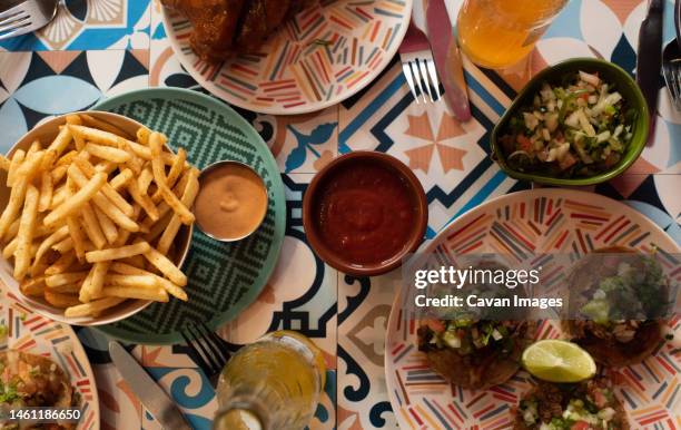 authentic mexican food on a table at a party - nachos guacamole stock pictures, royalty-free photos & images