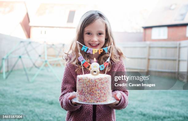 girl smiling celebrating her 8th birthday with a cake - day anniversary stock pictures, royalty-free photos & images