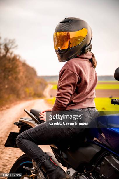 chilling on a moto journey - women black and white motorcycle fotografías e imágenes de stock
