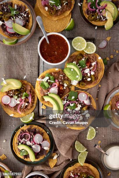 flat lay of salsa and tostadas for dinner - tostada stock pictures, royalty-free photos & images