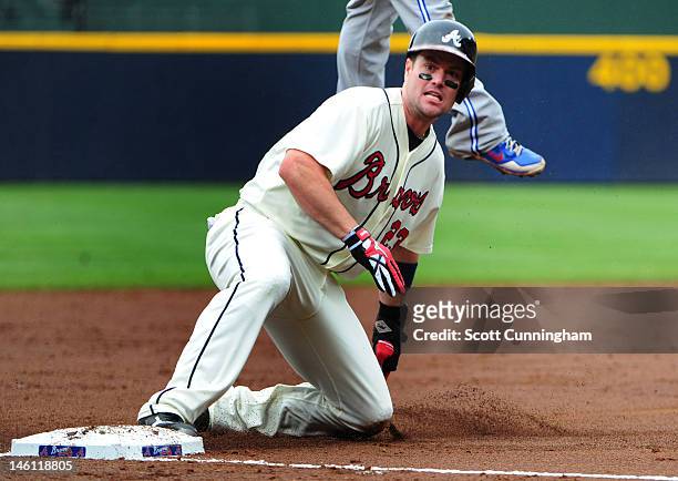 Matt Diaz of the Atlanta Braves slides in to third base against the Toronto Blue Jays at Turner Field on June 10, 2012 in Atlanta, Georgia.