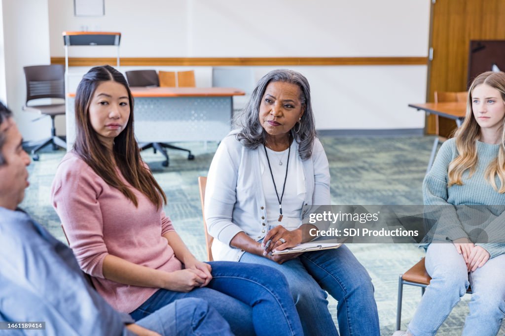 Diverse group empathizes with mature man in counseling