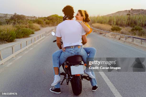 young couple travel happy by motorcycle on the road outdoors - verführung stock-fotos und bilder