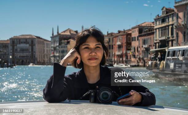 woman enjoying a boat taxi ride in venice - mirrorless camera bildbanksfoton och bilder