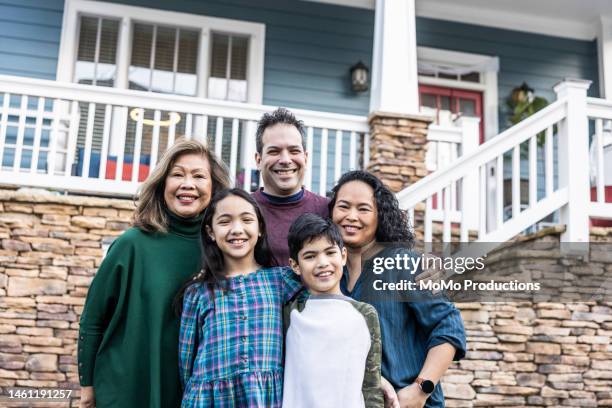 portrait of multi-generational family in front of urban home - assisted living community stock pictures, royalty-free photos & images