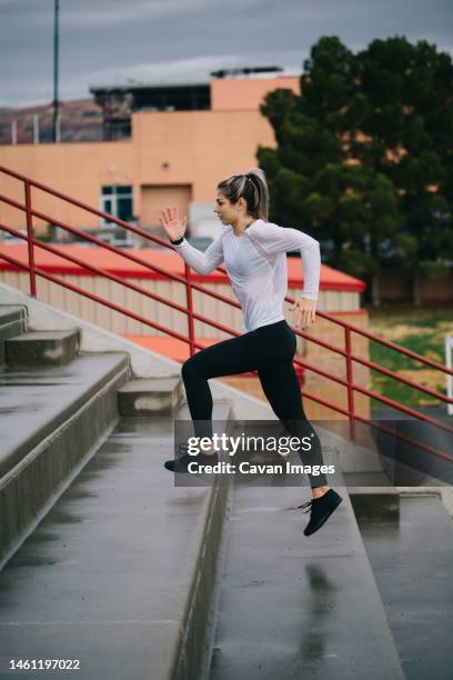 runner woman running stairs outside on a rainy day at college st - saint georges college stock pictures, royalty-free photos & images