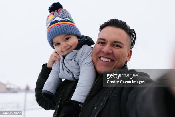 native american dad and son taking selfie together outside in th - kind child stock pictures, royalty-free photos & images