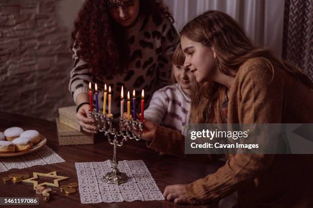 family celebration of the jewish holiday hanukkah at home - ドライデル ストックフォトと画像