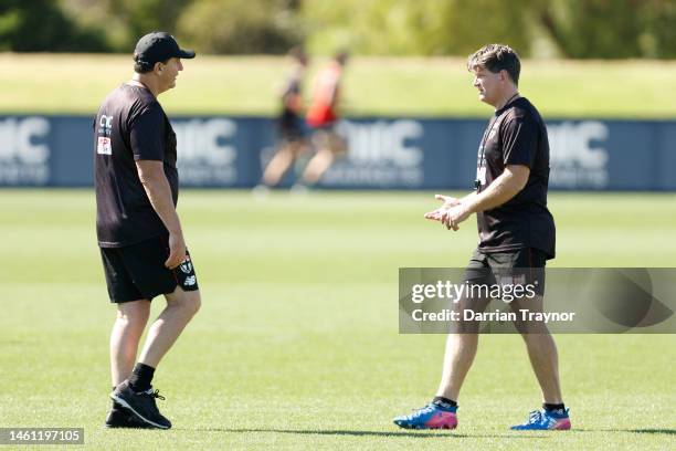 Ross Lyon, Senior Coach of the Saints speaks with Assistant coach Robert Harvey during a St Kilda Saints AFL training session at RSEA Park on...