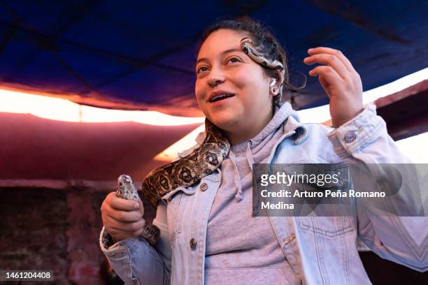 woman with a boa around her neck - boa constrictor stock pictures, royalty-free photos & images