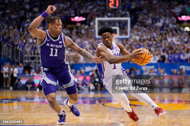 Joseph Yesufu of the Kansas Jayhawks drives to the basket against Keyontae Johnson of the Kansas State Wildcats in the first half at Allen Fieldhouse...