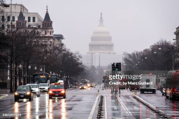 rainy day on a street leading to the united states capitol, washington, dc, usa - washington dc stock-fotos und bilder