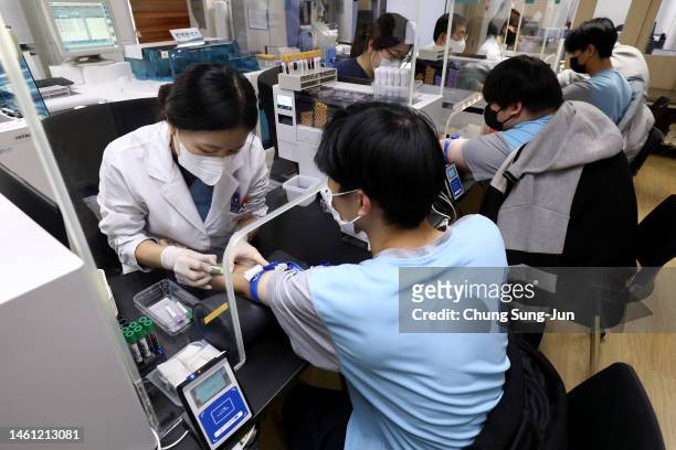 Teenagers are given blood tests during physical examinations for conscription at the Military Manpower Administration on February 01, 2023 in Seoul,...