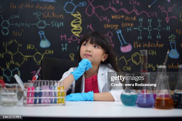schoolgirl in chemistry classroom, schoolgirl in contemplation while staying in chemistry laboratory class - school project stock pictures, royalty-free photos & images