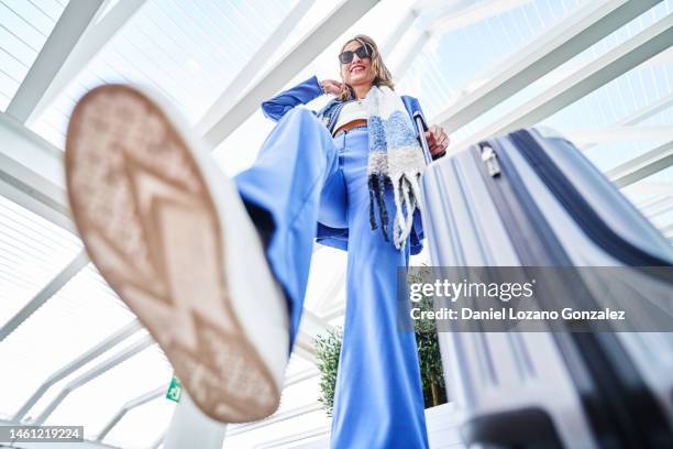 cheerful woman stepping the camera - blue suit portrait stock pictures, royalty-free photos & images