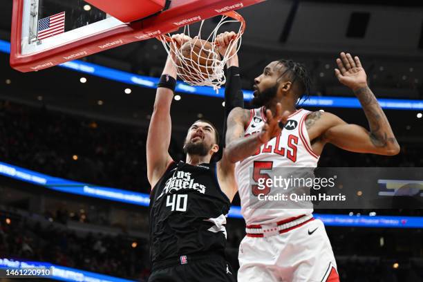 Ivica Zubac of the LA Clippers dunks in the second half against Derrick Jones Jr. #5 of the Chicago Bulls at United Center on January 31, 2023 in...
