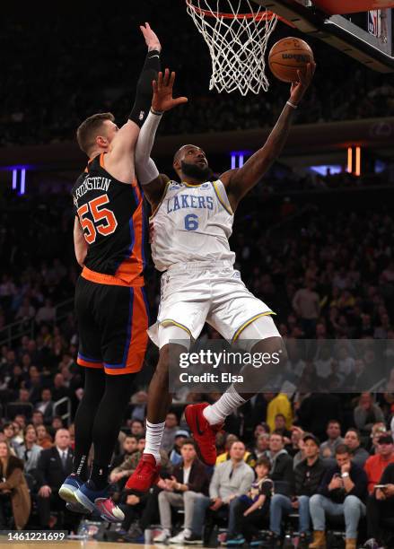 LeBron James of the Los Angeles Lakers heads for the net as Isaiah Hartenstein of the New York Knicks defends in the final minutes of the game at...