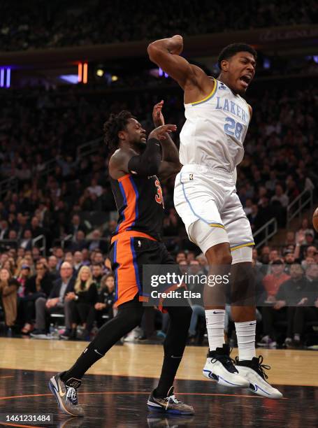 Rui Hachimura of the Los Angeles Lakers dunks as Julius Randle of the New York Knicks defends at Madison Square Garden on January 31, 2023 in New...